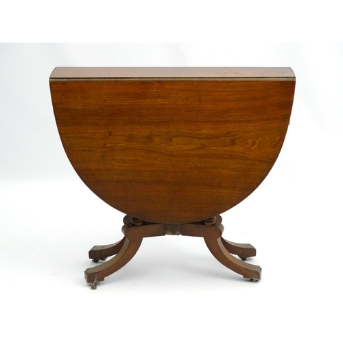 198 - An early 20thC walnut Sutherland table with central column surrounded by four turned supports, with ... 