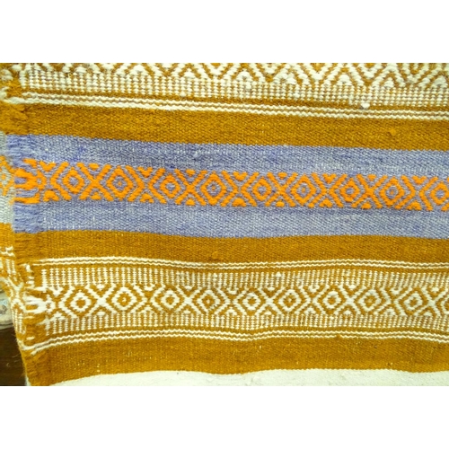 21 - A rug with orange, blue and white ground