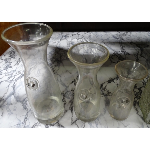 220 - A set of 3 graduated carafes, together with 3 assorted glass decanters