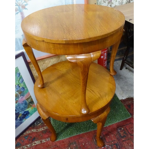 225 - A pair of oak circular occasional tables.