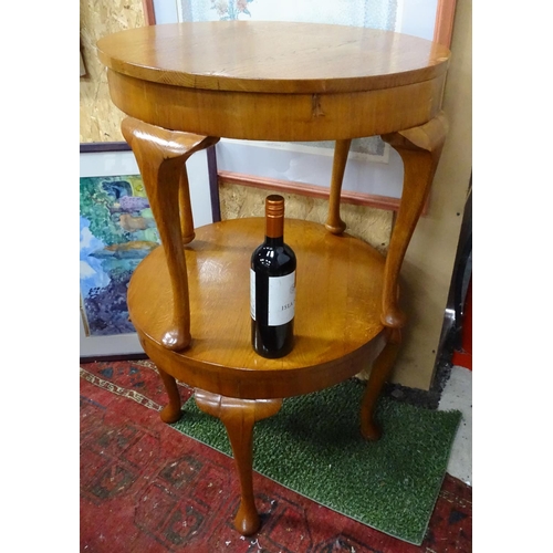 225 - A pair of oak circular occasional tables.