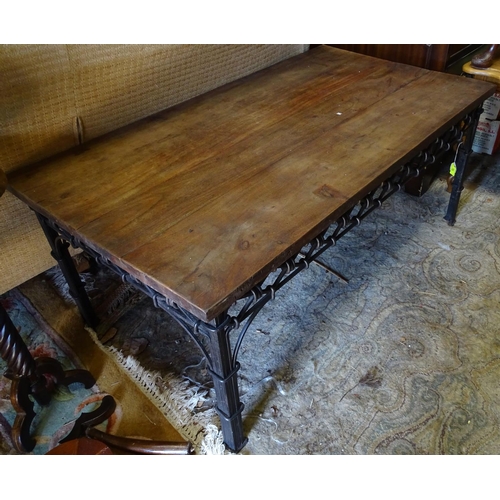 228 - A wrought iron coffee table with a mahogany top