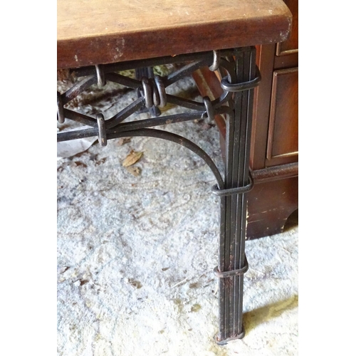 228 - A wrought iron coffee table with a mahogany top