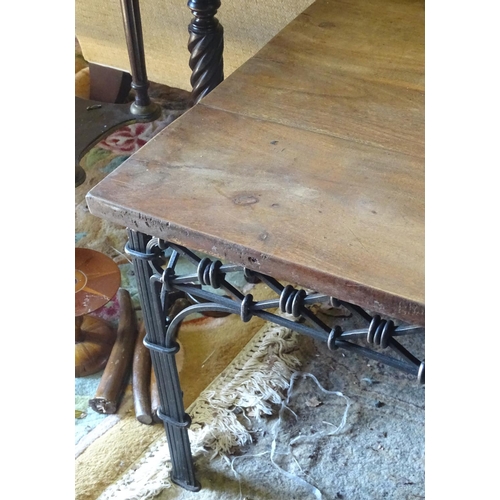 228 - A wrought iron coffee table with a mahogany top