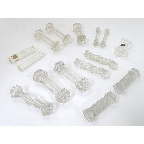 239 - Knife / Spoon rests : 14 assorted shaped glass rests , the largest measuring 4 1/4'' wide .