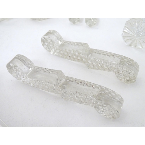 239 - Knife / Spoon rests : 14 assorted shaped glass rests , the largest measuring 4 1/4'' wide .