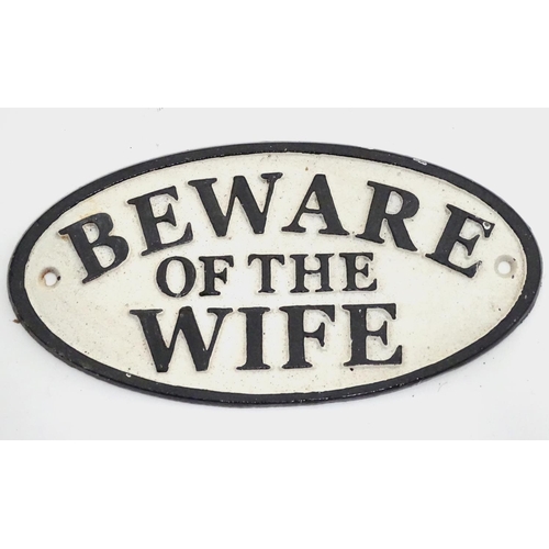 266 - A 21stC painted cast metal oval sign, 'beware of the wife', 7'' wide