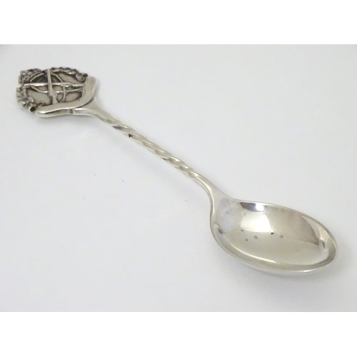 307 - A silver teaspoon with crossed rifle decoration to handle hallmarked Birmingham 1926 maker William J... 