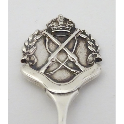 307 - A silver teaspoon with crossed rifle decoration to handle hallmarked Birmingham 1926 maker William J... 