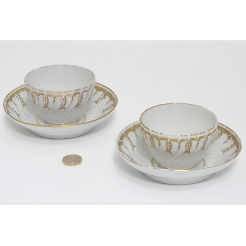 328 - A pair of hand painted coffee cups and saucers