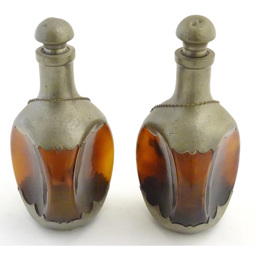 392 - A pair of dimple like brown glass and pewter mounted decanters with bottle tags marked 'Cognac' & 'W... 