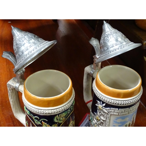 401 - A pair of German ceramic Stein mugs, with Munich decoration. Stamped under Gurz