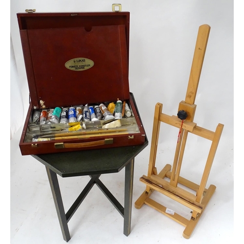 402 - A quantity of paints and an easel