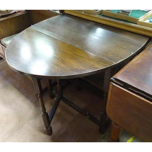 407 - A early 20thC dark stained oak oval gateleg table