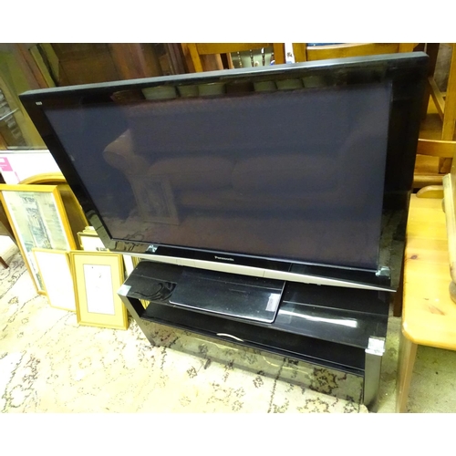 413 - A Panasonic TV / television and stand with a glass top, together with a sky box etc.