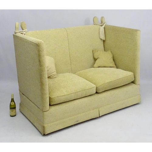 416 - Two Knole sofas: an early 21st oatmeal upholstered (generous) two seat settee with rope ties. 62'' w... 