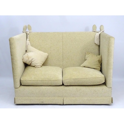 416 - Two Knole sofas: an early 21st oatmeal upholstered (generous) two seat settee with rope ties. 62'' w... 