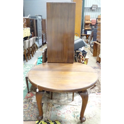 450 - A late 19thC/early 20thC walnut oval extending dining table