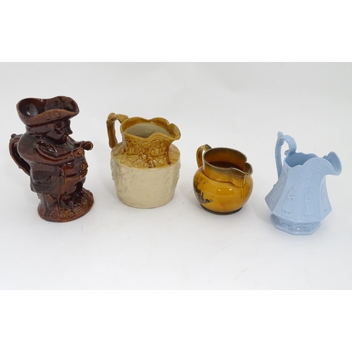 489 - 4 Victorian pottery jugs, to include a treacle glazed snuff taker Toby jug with a tricorn hat