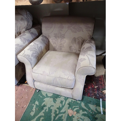 542 - A two seater sofa upholstered in beige with grey floral highlights, together with a matching armchai... 