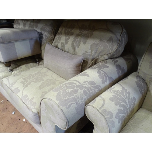 542 - A two seater sofa upholstered in beige with grey floral highlights, together with a matching armchai... 