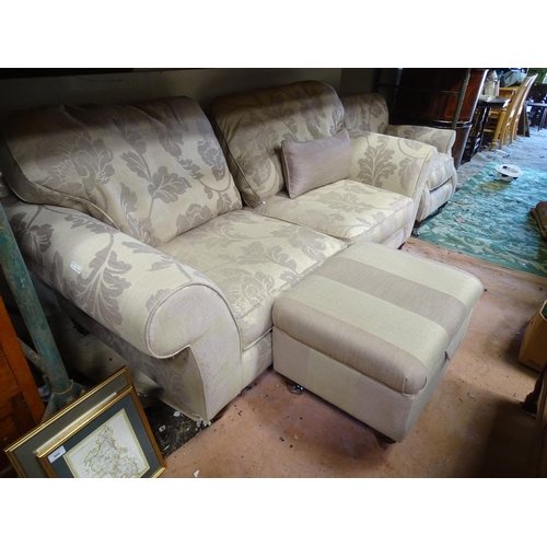 542 - A two seater sofa upholstered in beige with grey floral highlights, together with a matching armchai... 