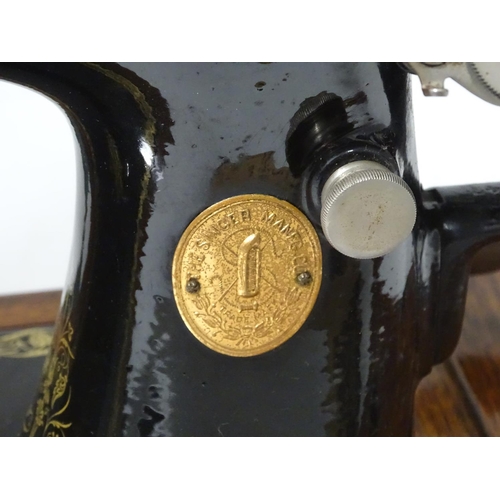 563 - A cased Singer sewing machine