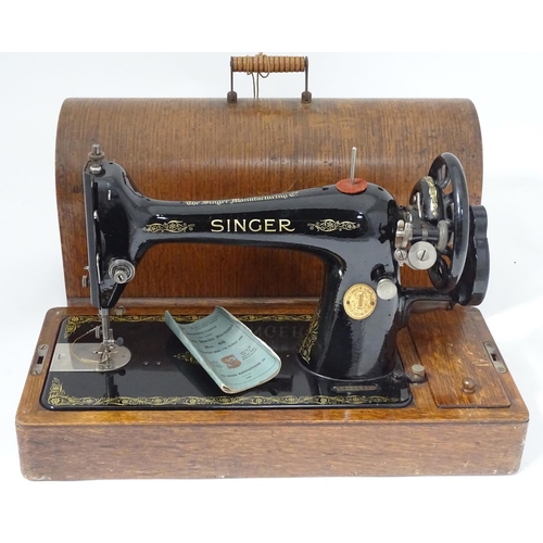 563 - A cased Singer sewing machine