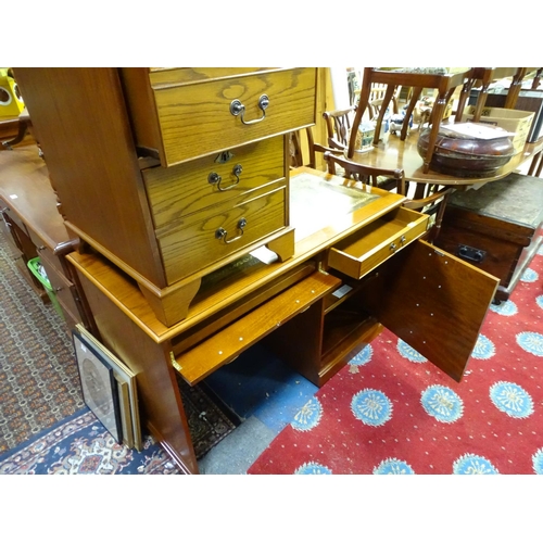 64 - An oak veneered and leather topped office desk with a pull out section for a keyboard, together with... 