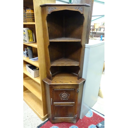 74 - An oak corner cupboard with rose detail