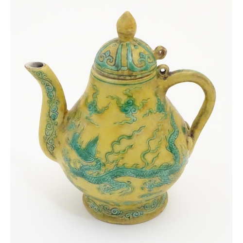 10 - A Chinese yellow ground small proportion lidded wine ewer decorated with green stylised dragons and ... 