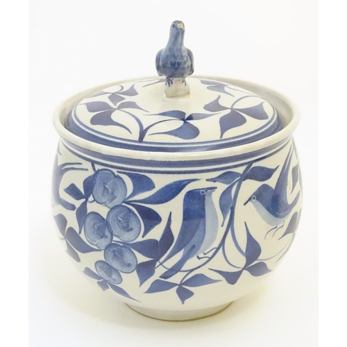 101 - A Laurence McGowan British studio pottery lidded pot, with hand painted decoration of birds amongst ... 