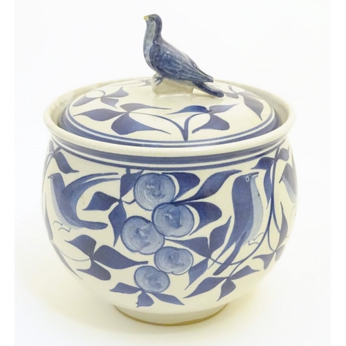 101 - A Laurence McGowan British studio pottery lidded pot, with hand painted decoration of birds amongst ... 