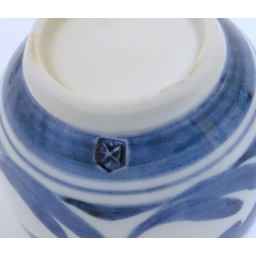 102 - A Derek Emms studio pottery lidded preserve pot, with blue and white stylised foliage decoration. In... 