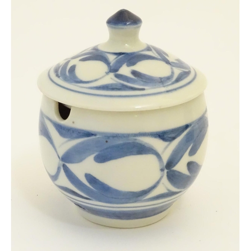 102 - A Derek Emms studio pottery lidded preserve pot, with blue and white stylised foliage decoration. In... 