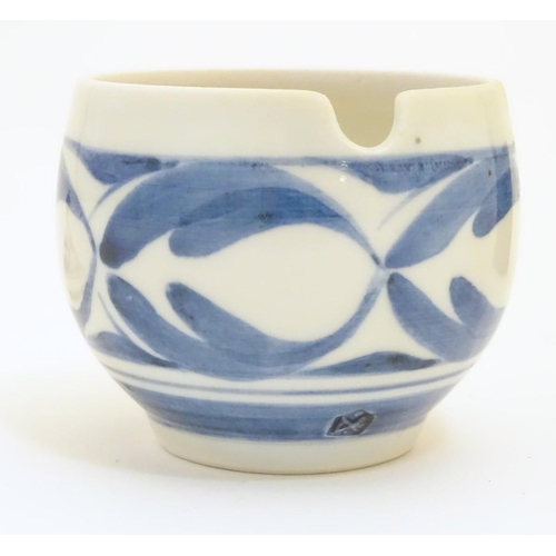 102 - A Derek Emms studio pottery lidded preserve pot, with blue and white stylised foliage decoration. In... 