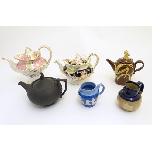 106 - A quantity of assorted teapots, to include a Wedgwood black basalt teapot with a female figural fini... 