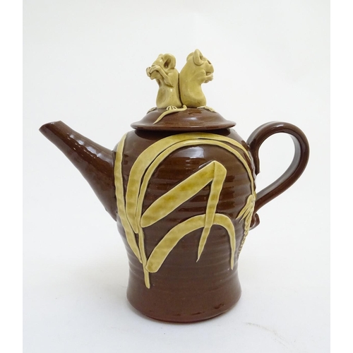 106 - A quantity of assorted teapots, to include a Wedgwood black basalt teapot with a female figural fini... 