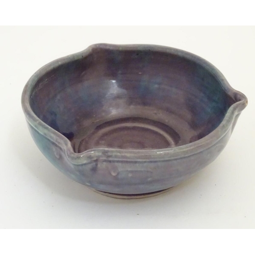 110 - A Baron Barnstable studio pottery dish / bowl with a mottled purple and blue glaze and three spout d... 