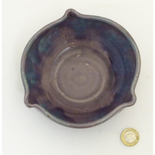 110 - A Baron Barnstable studio pottery dish / bowl with a mottled purple and blue glaze and three spout d... 