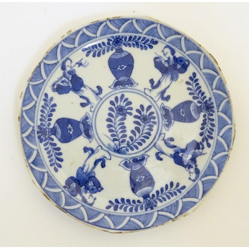 113 - A Chinese blue and white dish decorated with four baluster vases, four figures with attributes such ... 