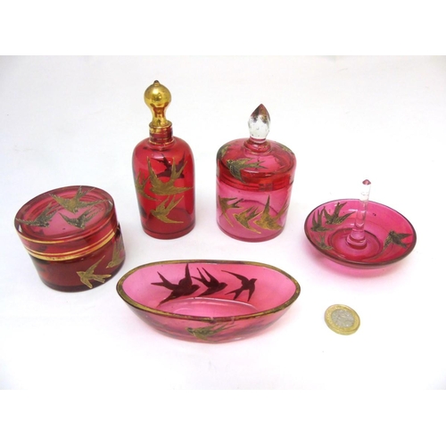 129 - Glass : a 5 piece c. 1910 Cranberry glass dressing table set with gilded swallow decoration , compri... 