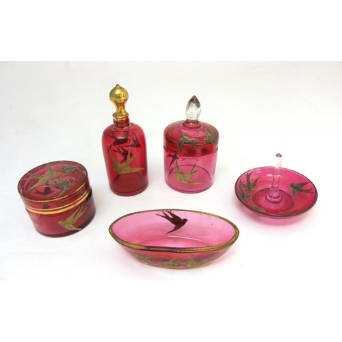 129 - Glass : a 5 piece c. 1910 Cranberry glass dressing table set with gilded swallow decoration , compri... 