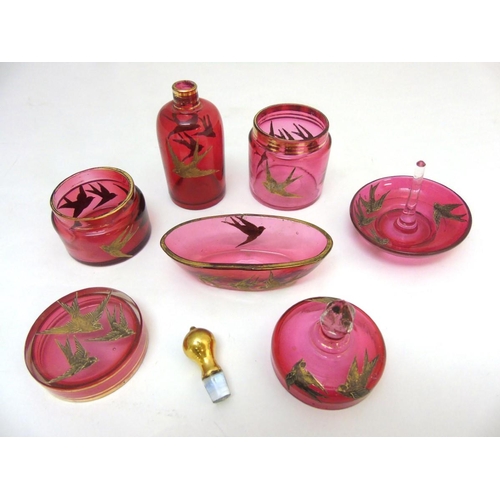 129 - Glass : a 5 piece c. 1910 Cranberry glass dressing table set with gilded swallow decoration , compri... 