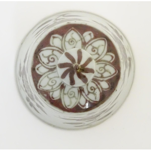 13 - A Chinese brown and white bell-shaped cover with floral decoration. 4'' high.