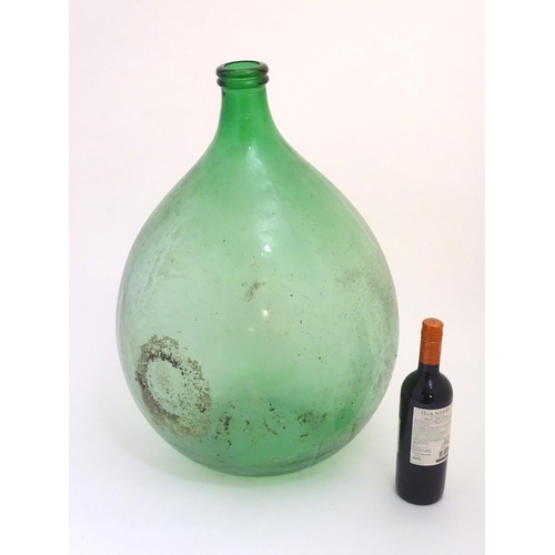 133 - Large Italian Demi-John Bottle: a large Carboy / Demi-John green glass wine bottle, 24 1/2'' high.