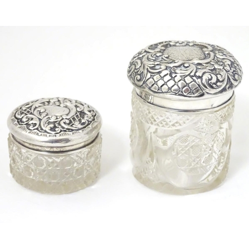 139 - 2 cut glass dressing table jars with silver tops one hallmarked Birmingham 1900 maker The Alexander ... 