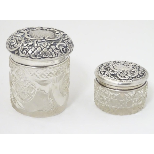 139 - 2 cut glass dressing table jars with silver tops one hallmarked Birmingham 1900 maker The Alexander ... 