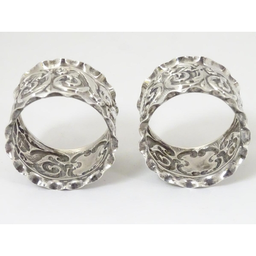 160 - A pair of silver napkin rings with winged cherub detail. Hallmarked Chester 1900 maker J & R Griffin... 