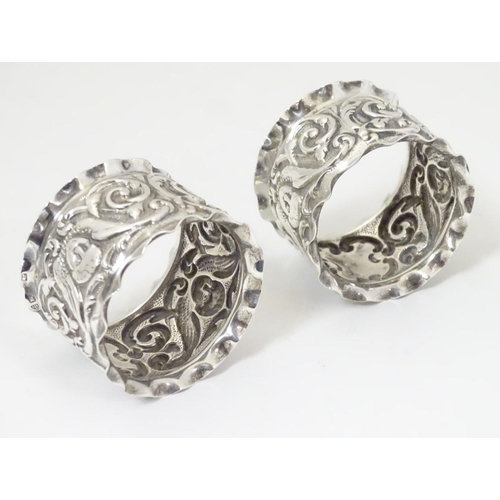 160 - A pair of silver napkin rings with winged cherub detail. Hallmarked Chester 1900 maker J & R Griffin... 